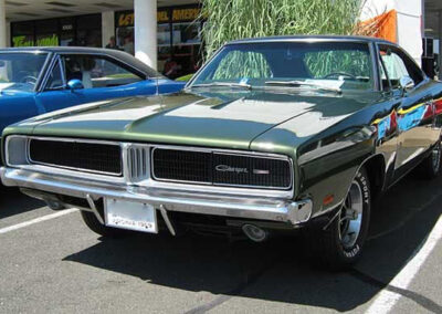 1969 Dodge Charger in green, showcasing classic car restoration by Wilson Auto Repair, parked in a display area.