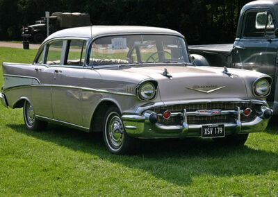 1957 Chevrolet Bel Air four-door sedan parked on grass, showcasing classic car restoration by Wilson Auto Repair.